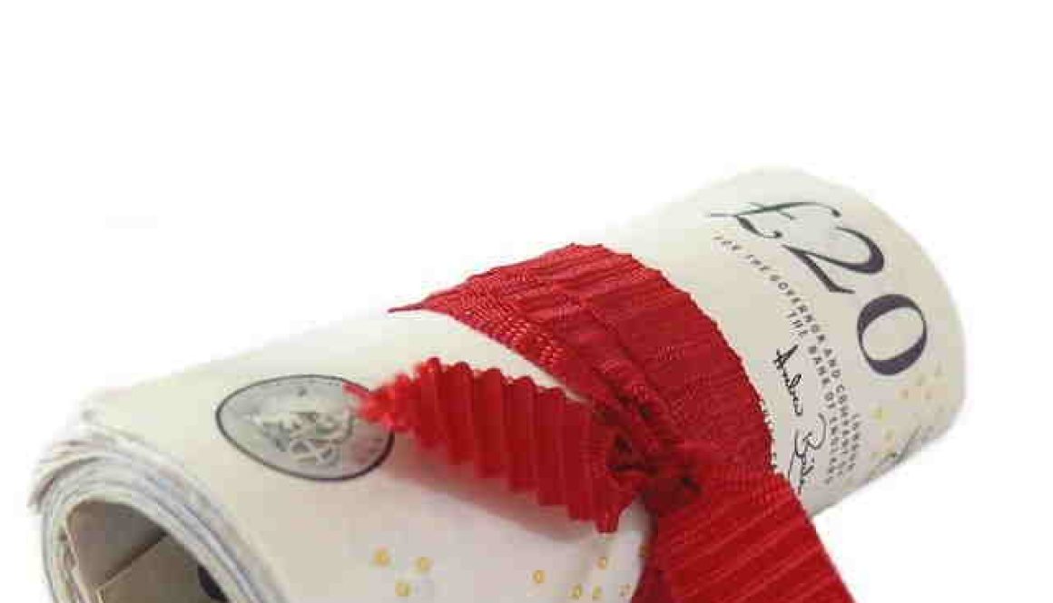 Roll of bank notes in a red ribbon