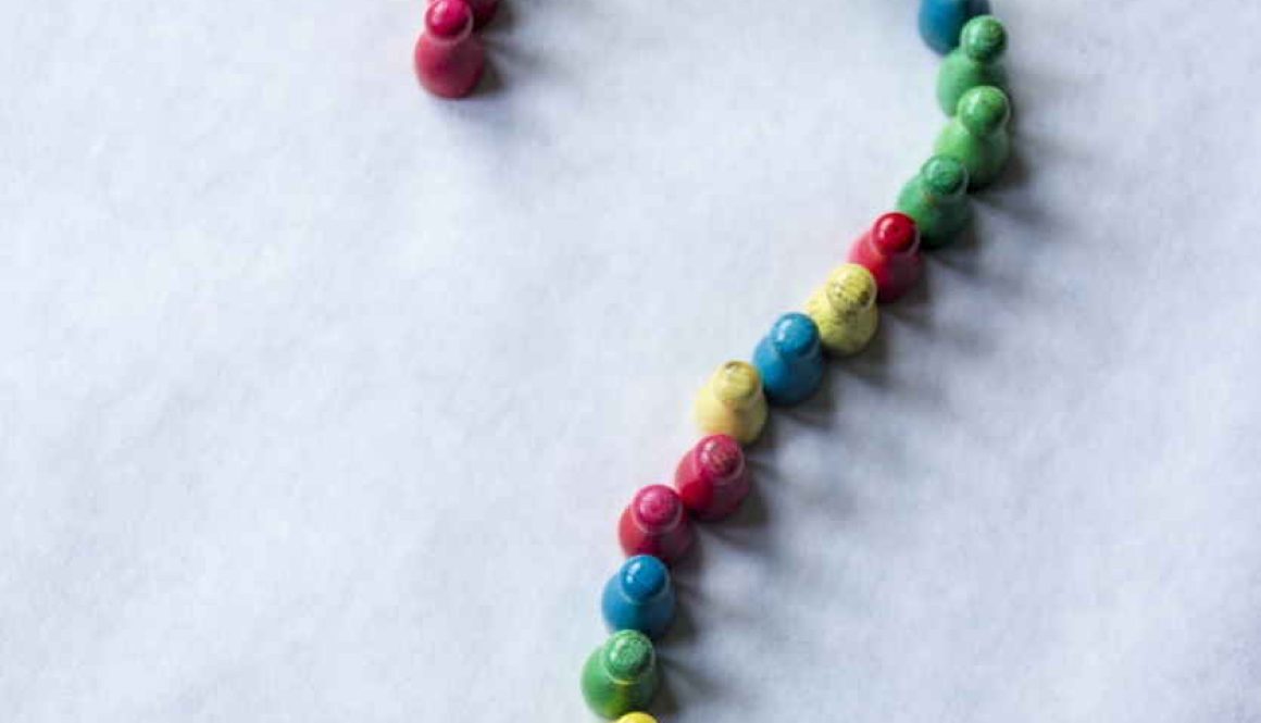 Question mark made from small wooden skittles ready to tumble