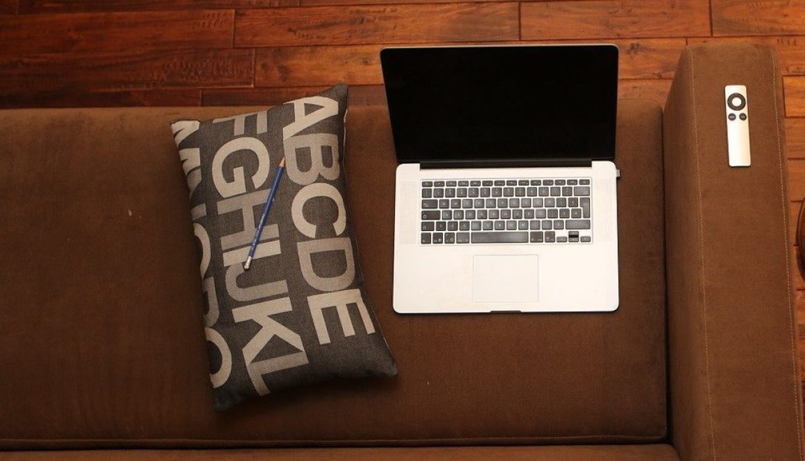 Laptop on the sofa with a cushion