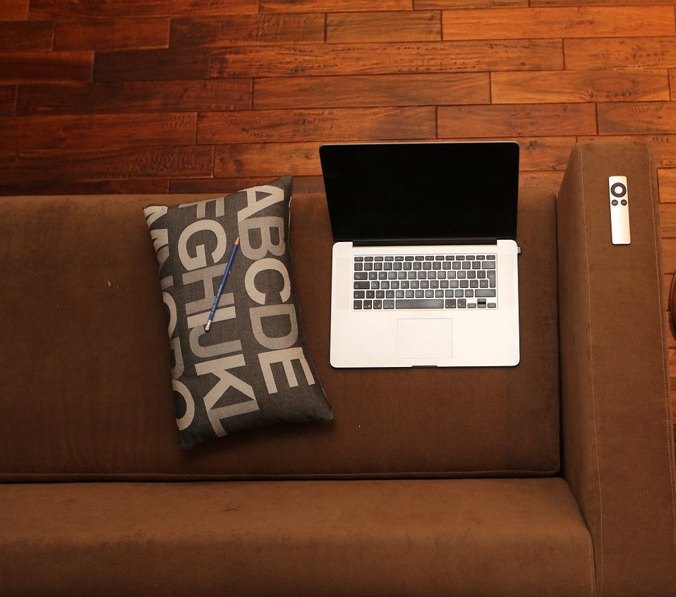 Laptop on the sofa with a cushion