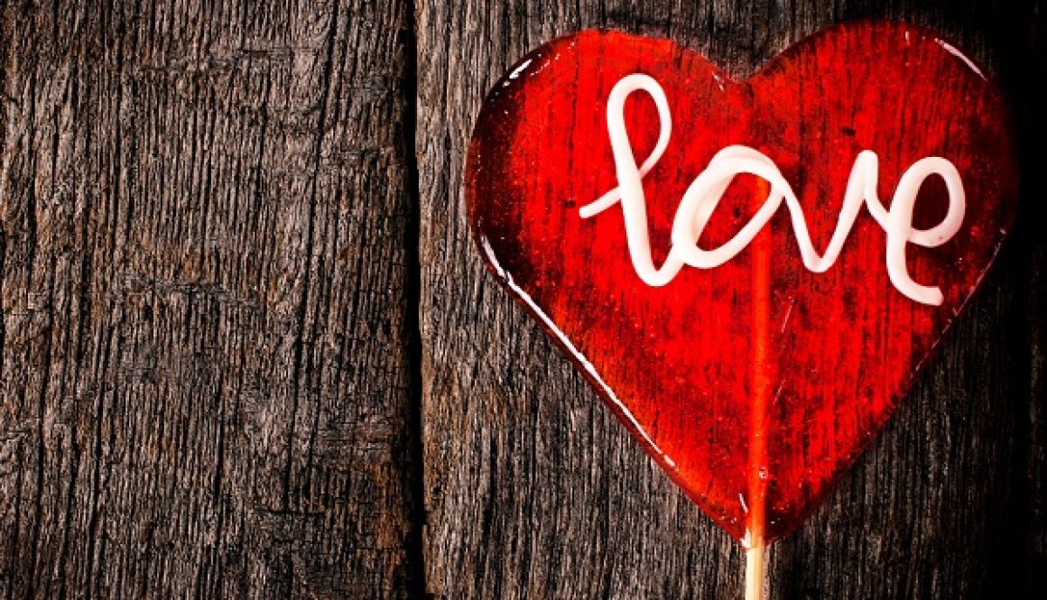 'Love' in a heart on a wooden background