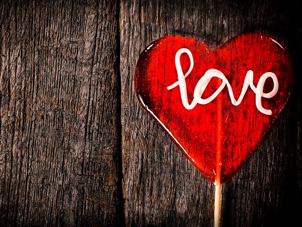 'Love' in a heart on a wooden background